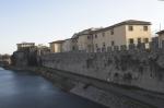 Tratto di mura lungo il fiume Bisenzio, nello sfondo si pu notare la Casa del Fascio.